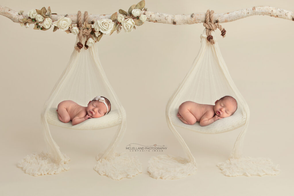 Twin newborns posed in hanging cream swings for a fine-art composite portrait.