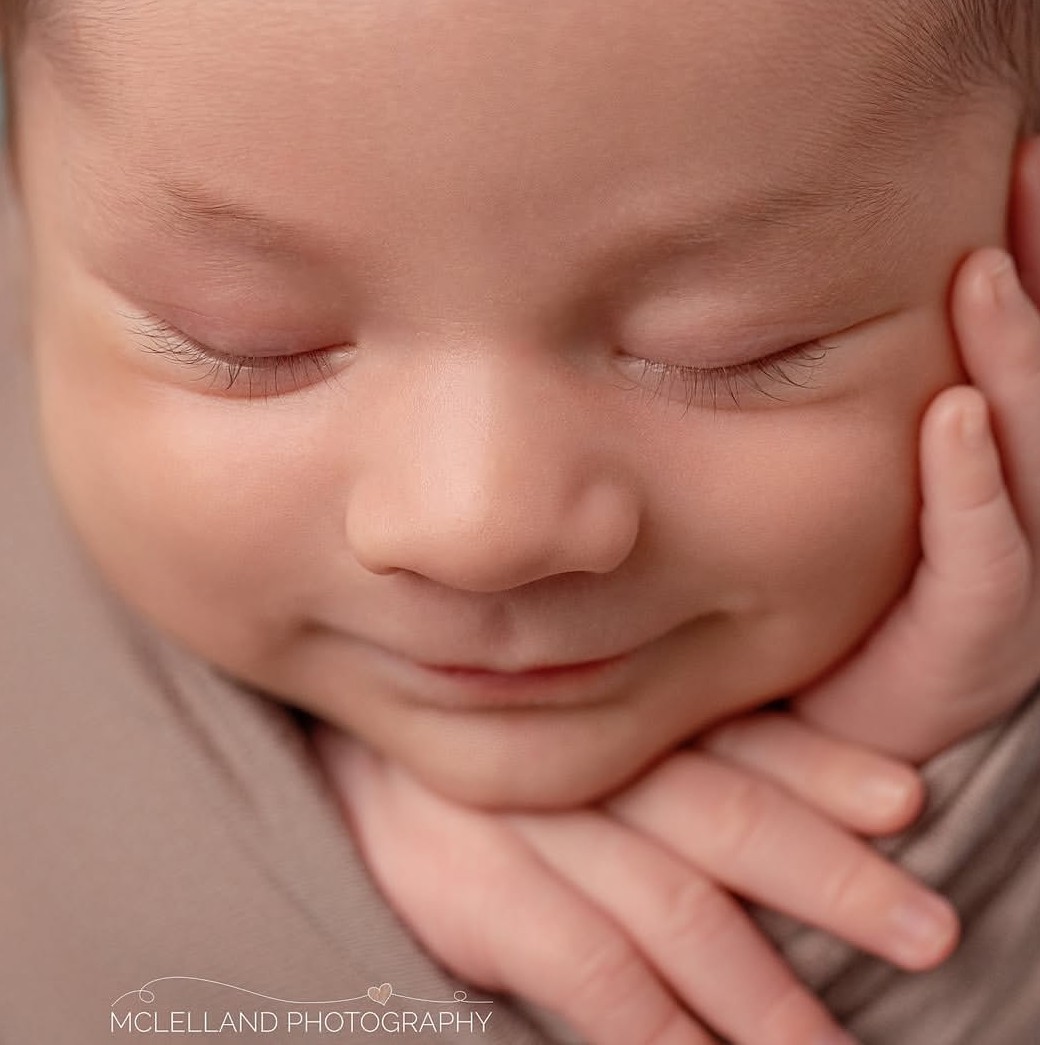 safely posed newborn during their photo session thanks to a newborn photography safety course taking by the photographer