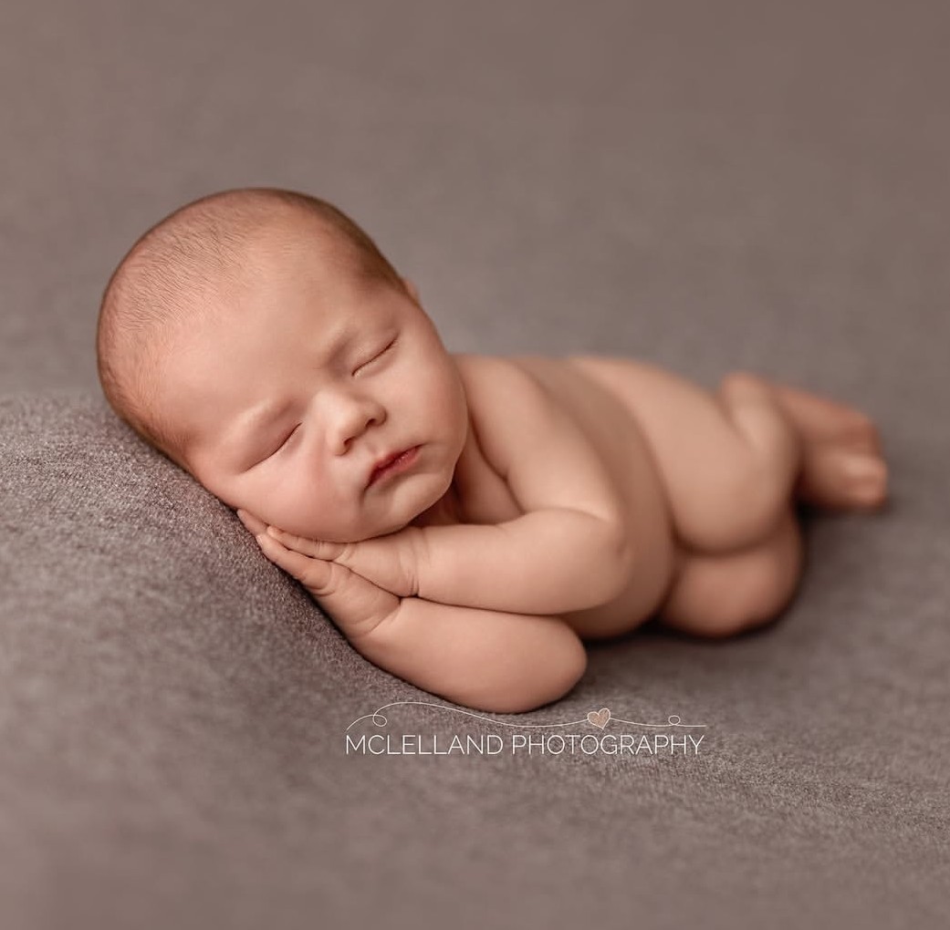 newborn safety training in action during a newborn photoshoot by mclelland photography