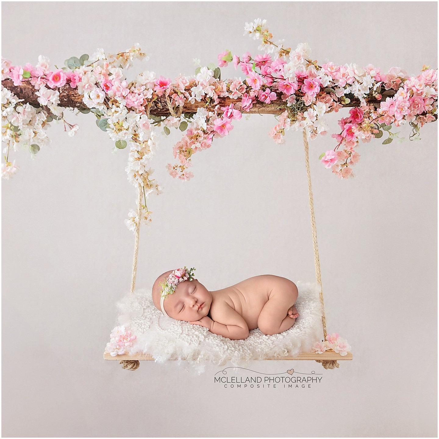Newborn baby sleeping on a floral swing in a professional composite image