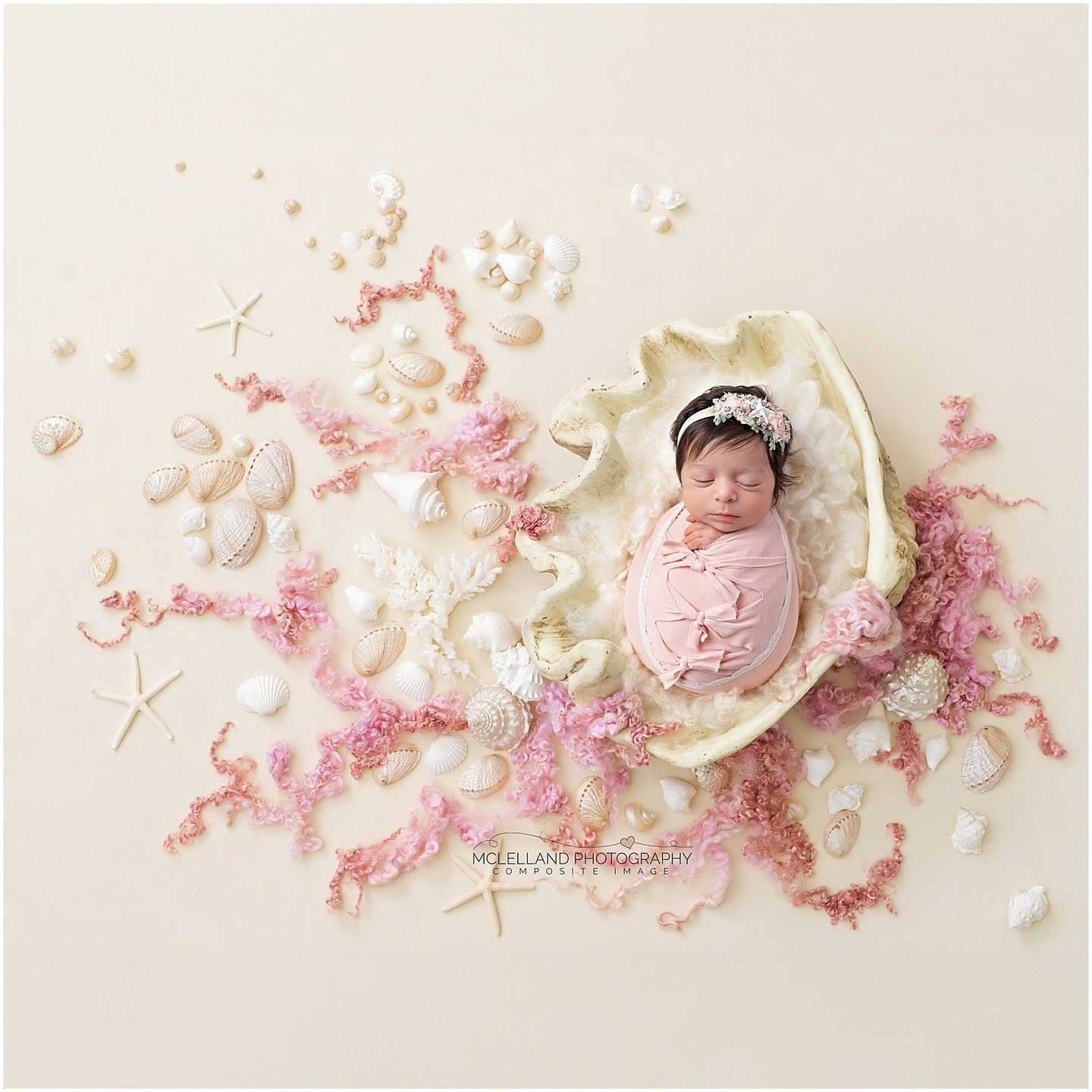 Newborn baby wrapped in pink and posed in a seashell-themed composite portrait